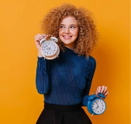Woman holding an alarm clock — Top BPO Solutions | Outsourcing Services In The Philippines