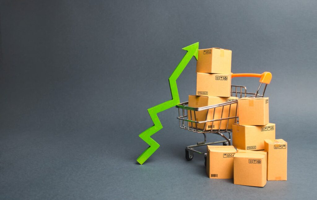 Shopping cart with cardboard boxes and a green up arrow — Sourcefit
