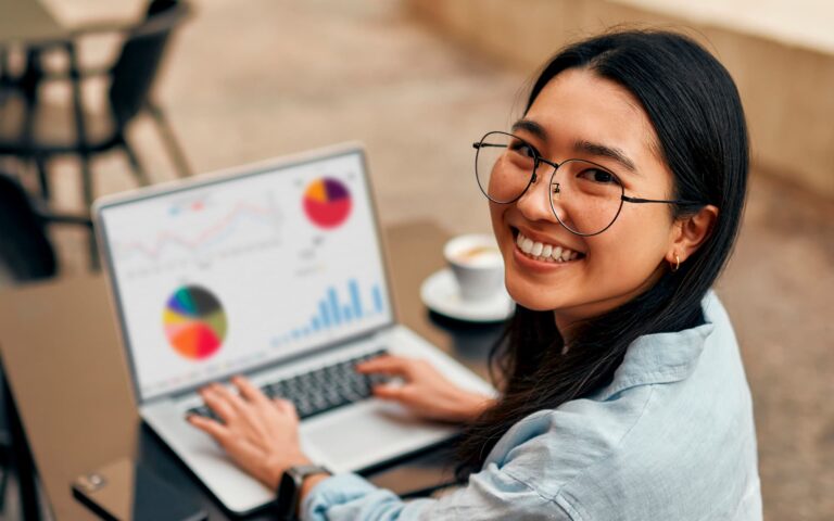 Asian female working on graphs — Top BPO Solutions | Outsourcing Services In The Philippines