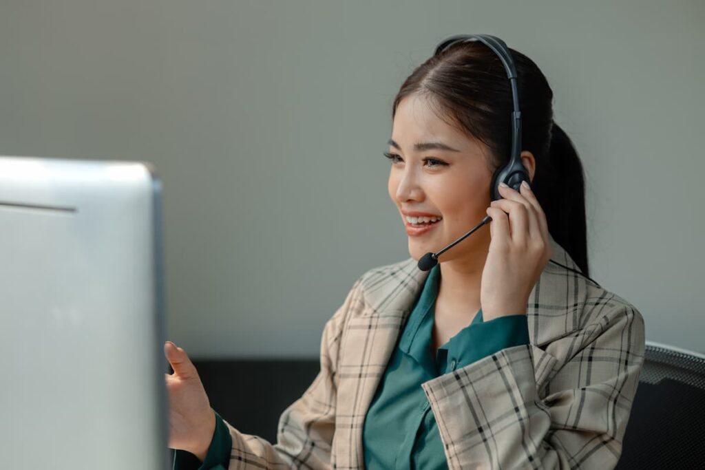 Happy agent speaking on her headset — Business process outsourcing & offshore staffing | Sourcefit