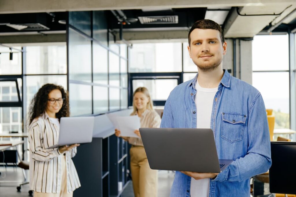 Tech guy lifting his laptop — Business process outsourcing & offshore staffing | Sourcefit