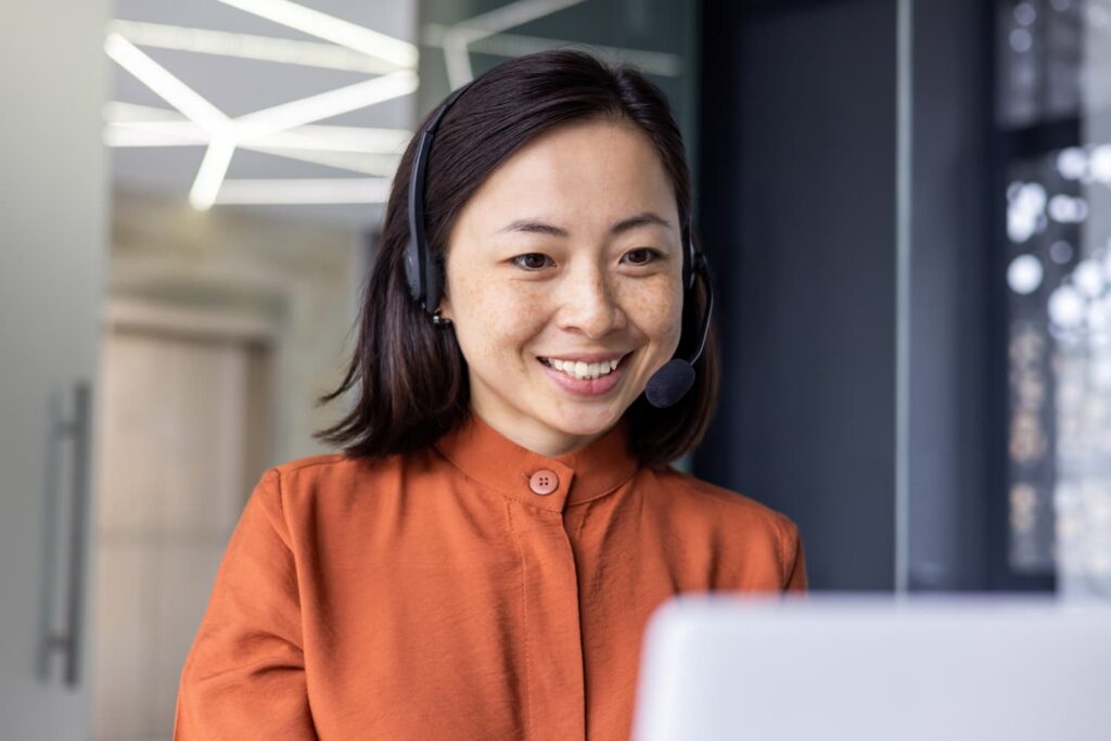 Close up photo of young beautiful woman talking on headset — Business process outsourcing & offshore staffing | Sourcefit