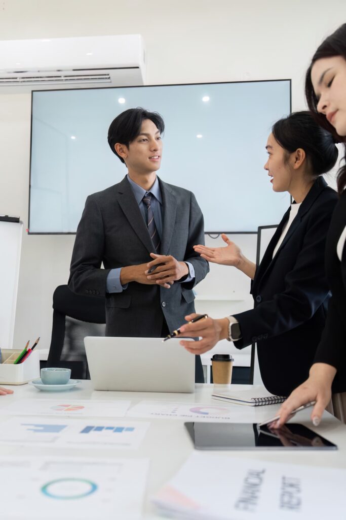 Male and female asian workers talking — Business process outsourcing & offshore staffing | Sourcefit