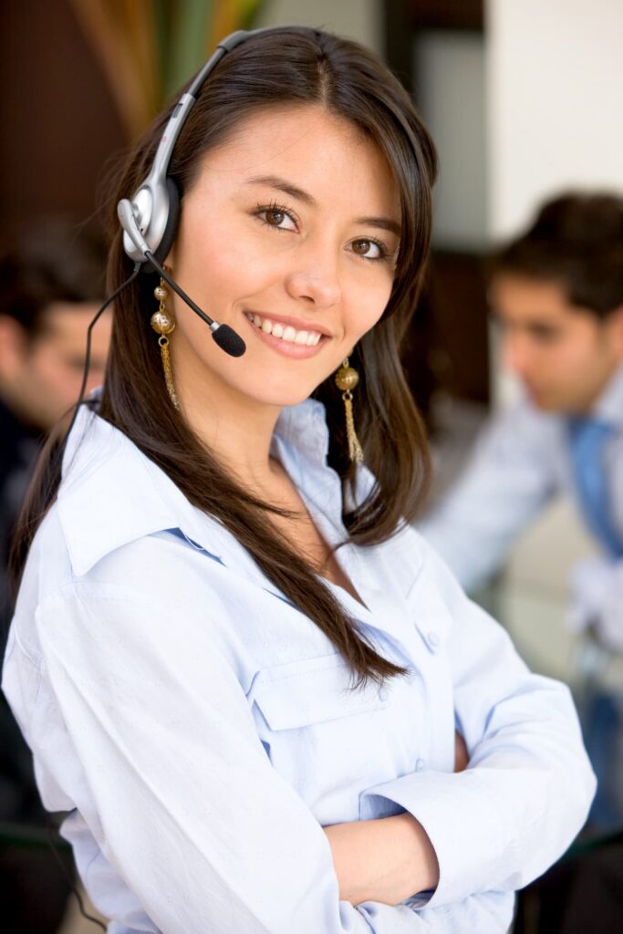 Smiling lady agent wearing a headset — Business process outsourcing & offshore staffing | Sourcefit
