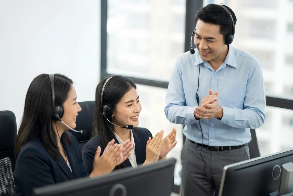 Happy team clapping — Business process outsourcing & offshore staffing | Sourcefit