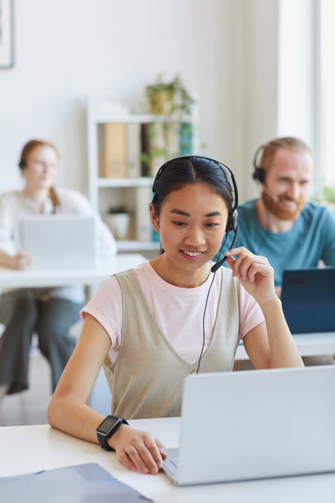 Lady wearing headset speaking with a client — Business process outsourcing & offshore staffing | Sourcefit