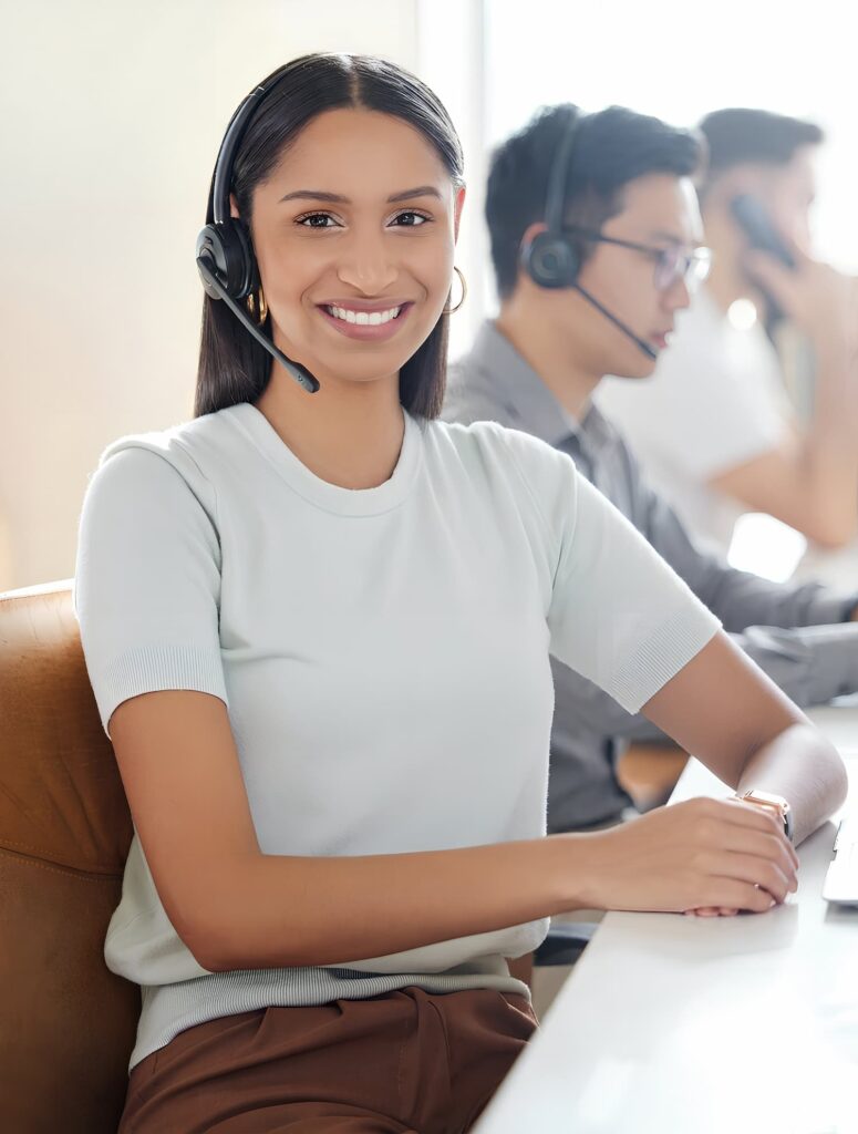 Woman wearing a headset smiling — Business process outsourcing & offshore staffing | Sourcefit