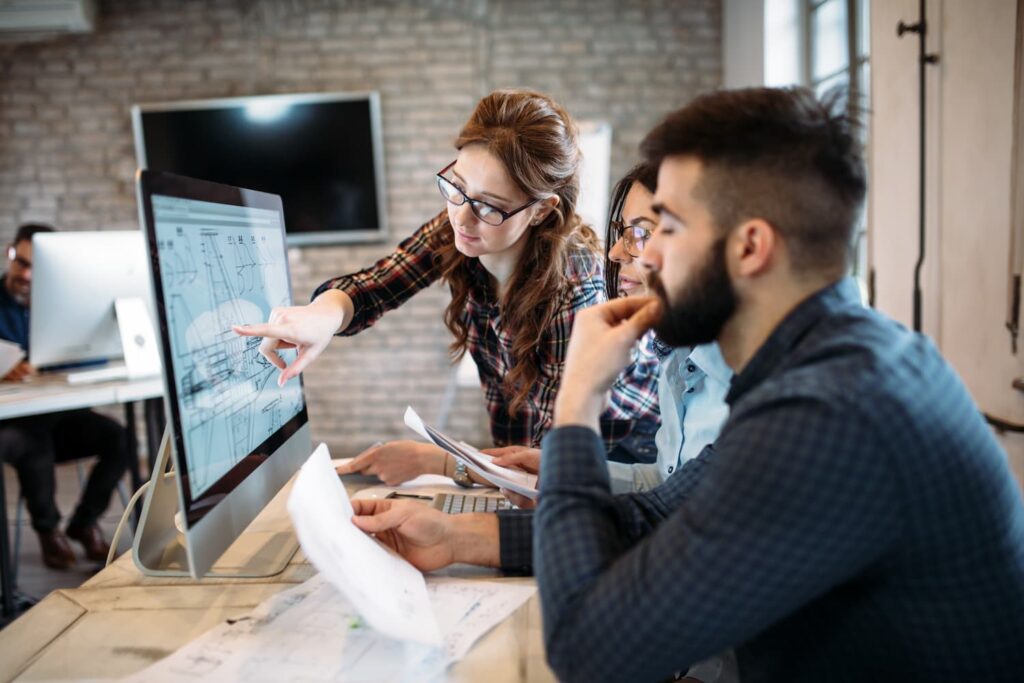 Young architects working on project in office — Business process outsourcing & offshore staffing | Sourcefit