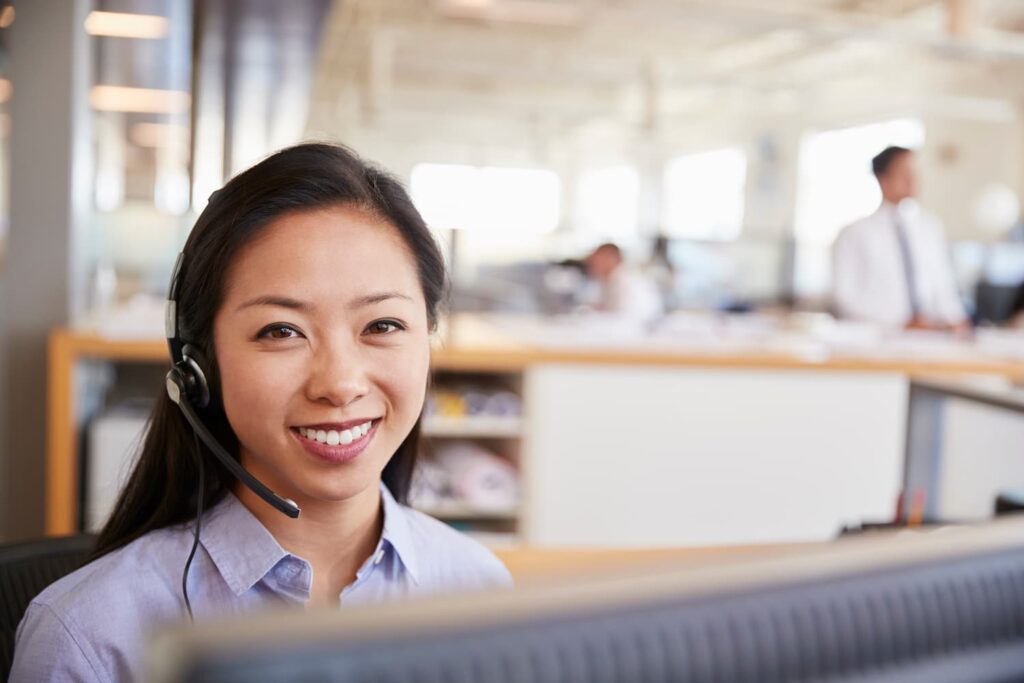 Asian lady wearing a headset — Business process outsourcing & offshore staffing | Sourcefit