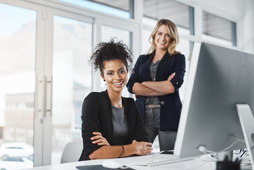 Two professional workers smiling — Offshore Staffing & BPO Across 6 Countries
