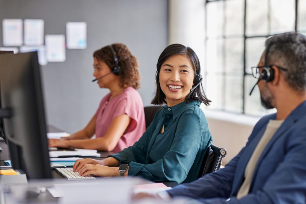 Cheerful agents working in a call center — Offshore Staffing & BPO Across 6 Countries
