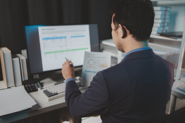 Finance analyst reviewing documents: Offshore Staffing & BPO Across 6 Countries