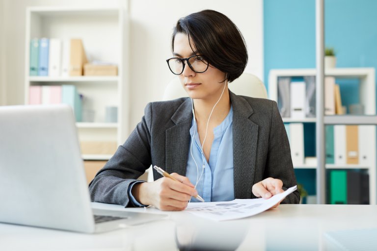 Compliance analyst reviewing regulatory documents: Offshore Staffing & BPO Across 6 Countries