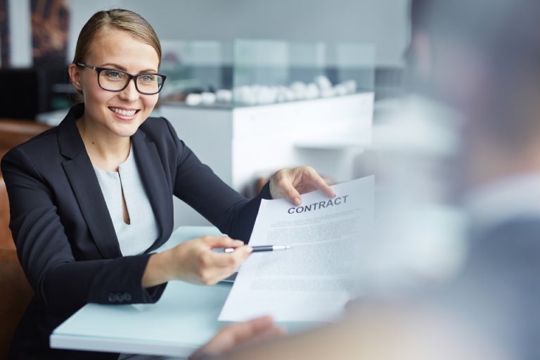 Contract administrator reviewing legal document: Offshore Staffing & BPO Across 6 Countries