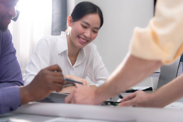 Loan processing specialist reviewing documents: Offshore Staffing & BPO Across 6 Countries
