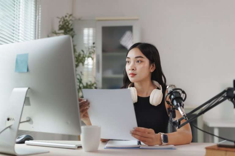 Podcast production specialist at desk: Offshore Staffing & BPO Across 6 Countries