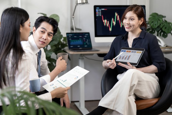 Compliance analysts reviewing financial charts: Offshore Staffing & BPO Across 6 Countries