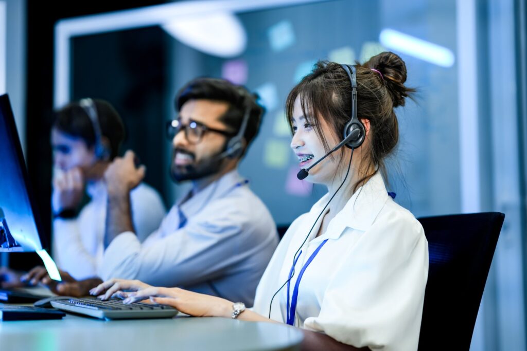 Call center agents wearing headsets at workstations: Offshore Staffing & BPO Across 6 Countries