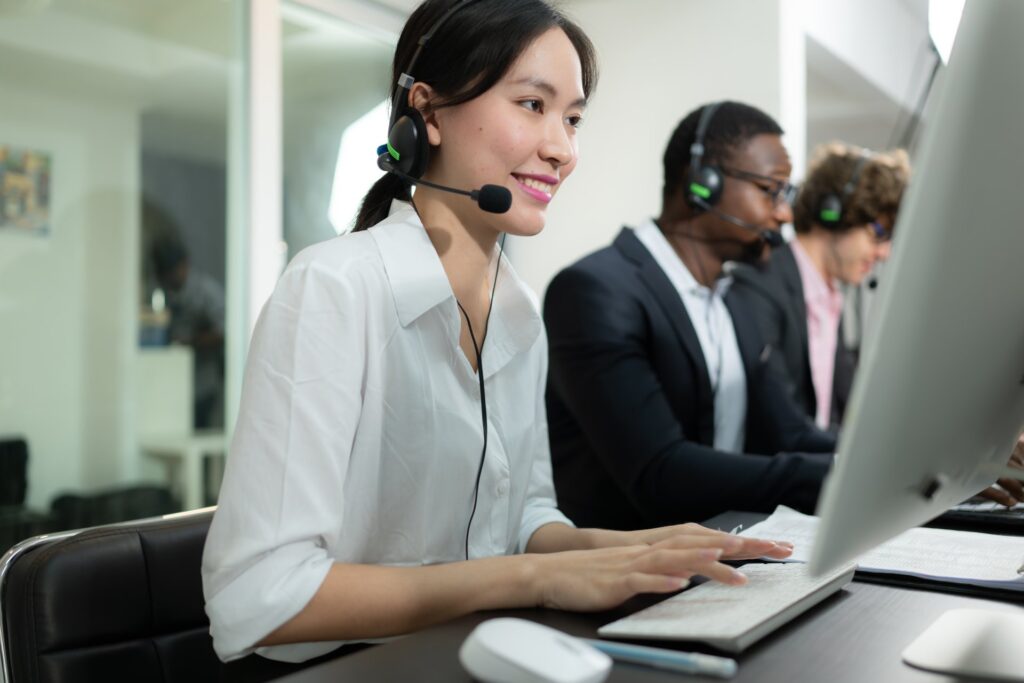 Diverse customer support agents working with headsets: Offshore Staffing & BPO Across 6 Countries