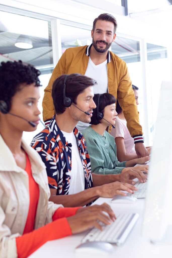 Sourcefit lending support team at desks: Offshore Staffing & BPO Across 6 Countries
