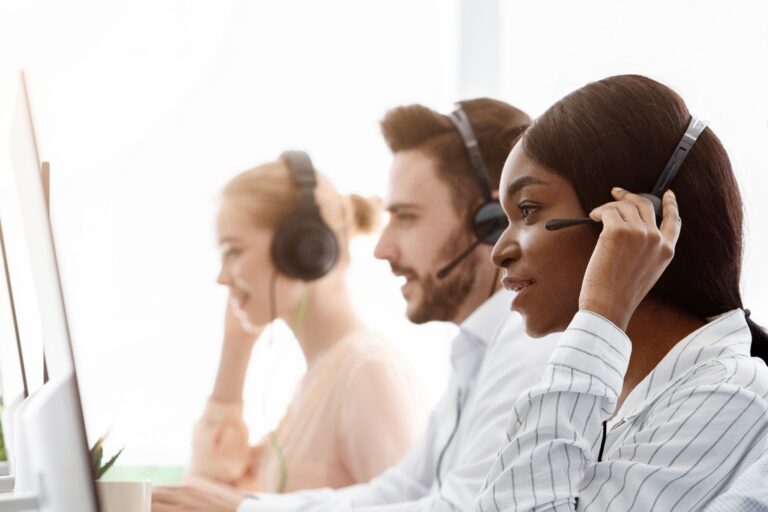 Support agents with headsets assisting guests: Offshore Staffing & BPO Across 6 Countries