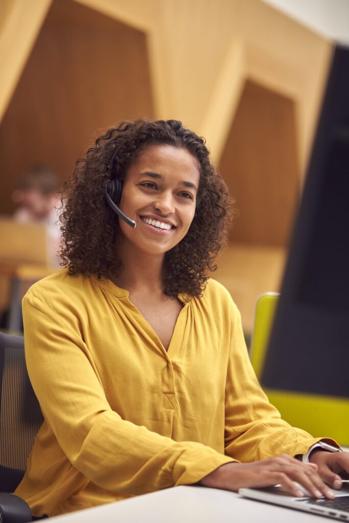 Woman working at a computer in an office: Offshore Staffing & BPO Across 6 Countries
