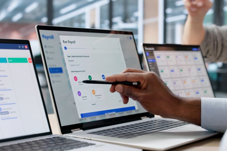 Hand pointing at scheduling dashboard on laptop: Offshore Staffing & BPO Across 6 Countries