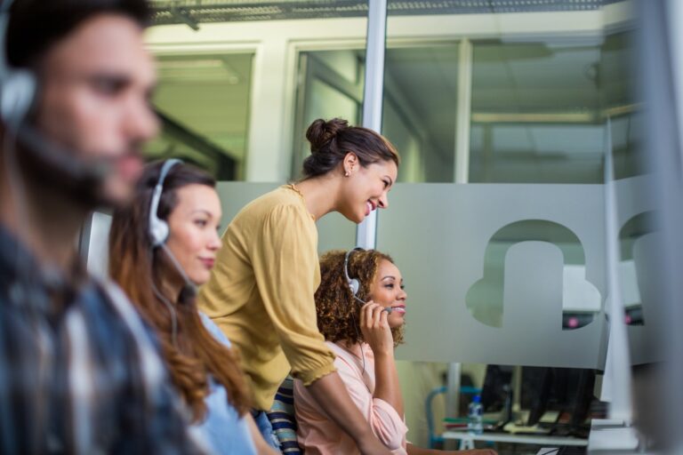 Support team with headsets at desks: Offshore Staffing & BPO Across 6 Countries